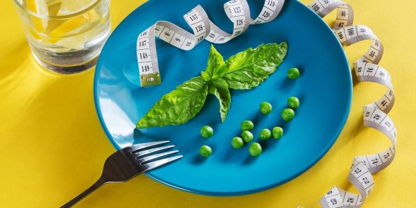 Diet blue plate with centimeter peas and basil