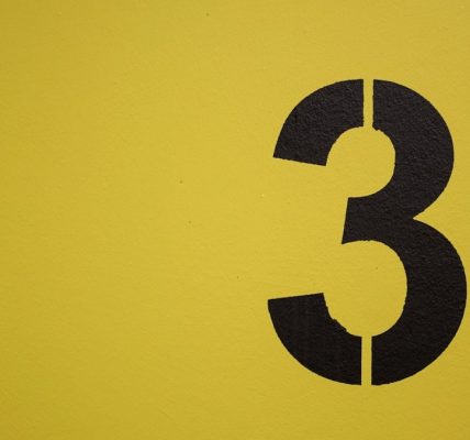 Black number three stenciled on yellow background