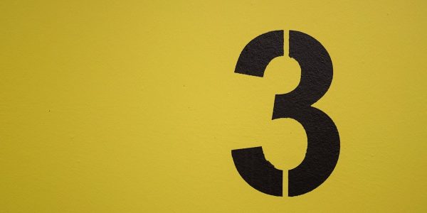 Black number three stenciled on yellow background